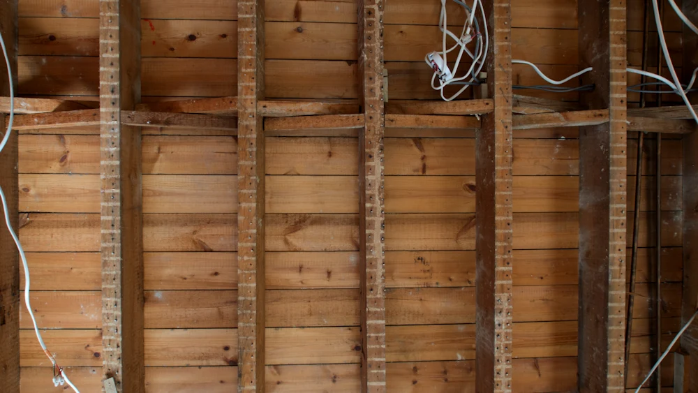 New electrical cable stapled along wood framing.