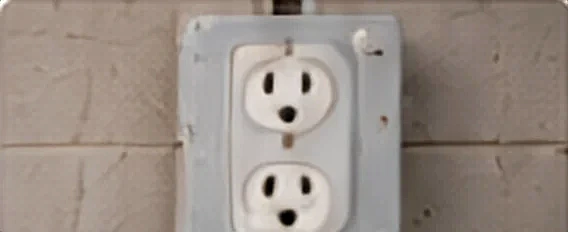 A replaced duplex outlet on a block wall.